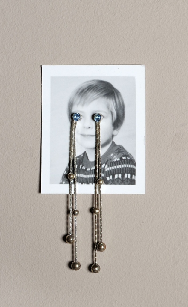 Jonathan Monk, In Edition (to tears), 2006 Passport photograph and earrings; edition 47 of 50 3 ⅜ x 1 ¾ in. Linda Pace Foundation Collection, Ruby City, San Antonio, Texas